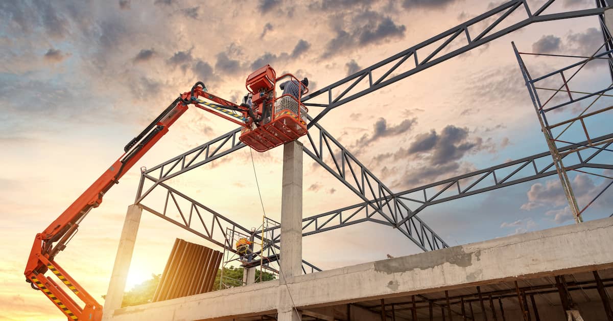 Construction worker up on an aerial lift. | Patrick Daniel Law