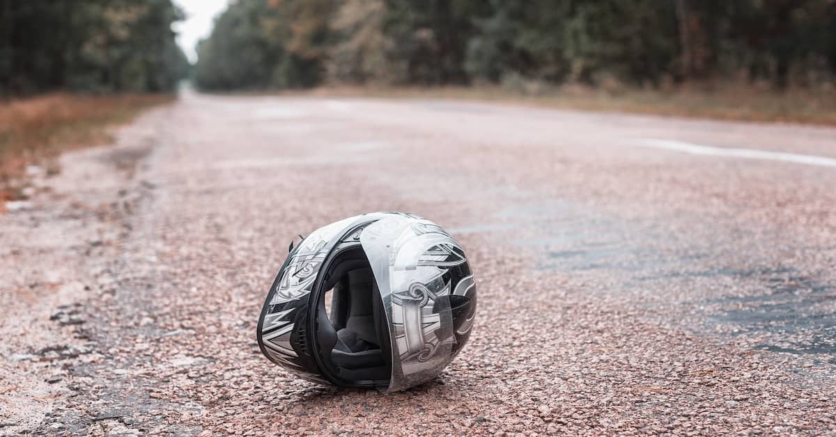 Motorcycle helmet on blacktop. | Patrick Daniel Law